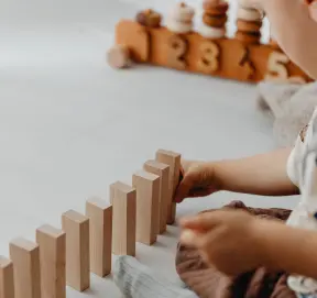 Child playing with wooden counting toys