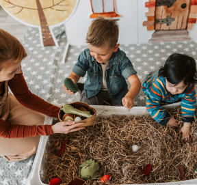 Children enjoying sensory play with a nature tray